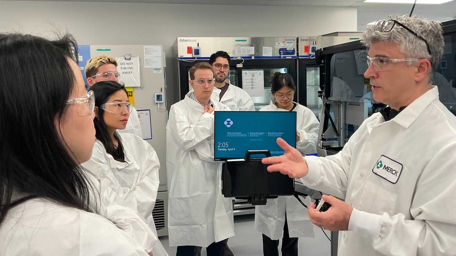 A Merck scientist walking the Benchling team through the lab during an on-site visit